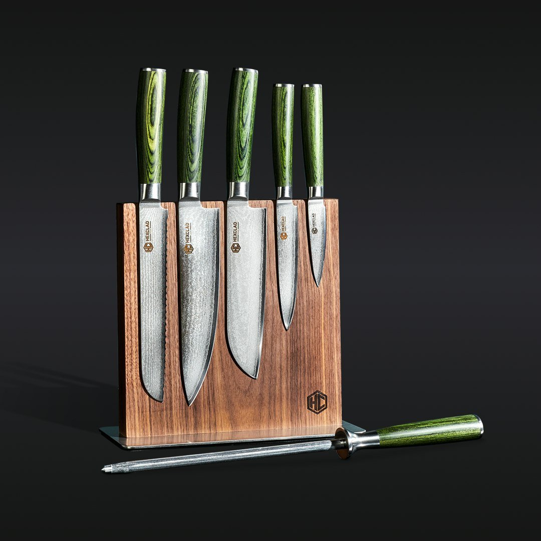 Set of five kitchen knives with green handles in a wooden block.