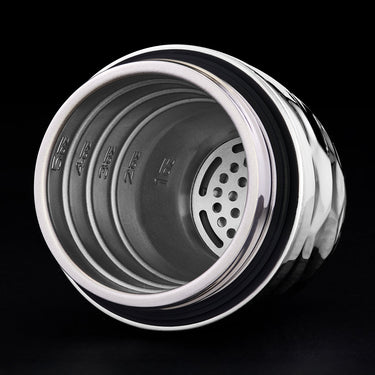 Close-up of a hexclad cocktail shaker top showing the inside with a black background