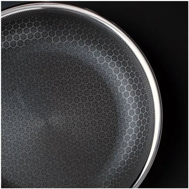 Close-up of a speaker grille with a hexagonal pattern design.